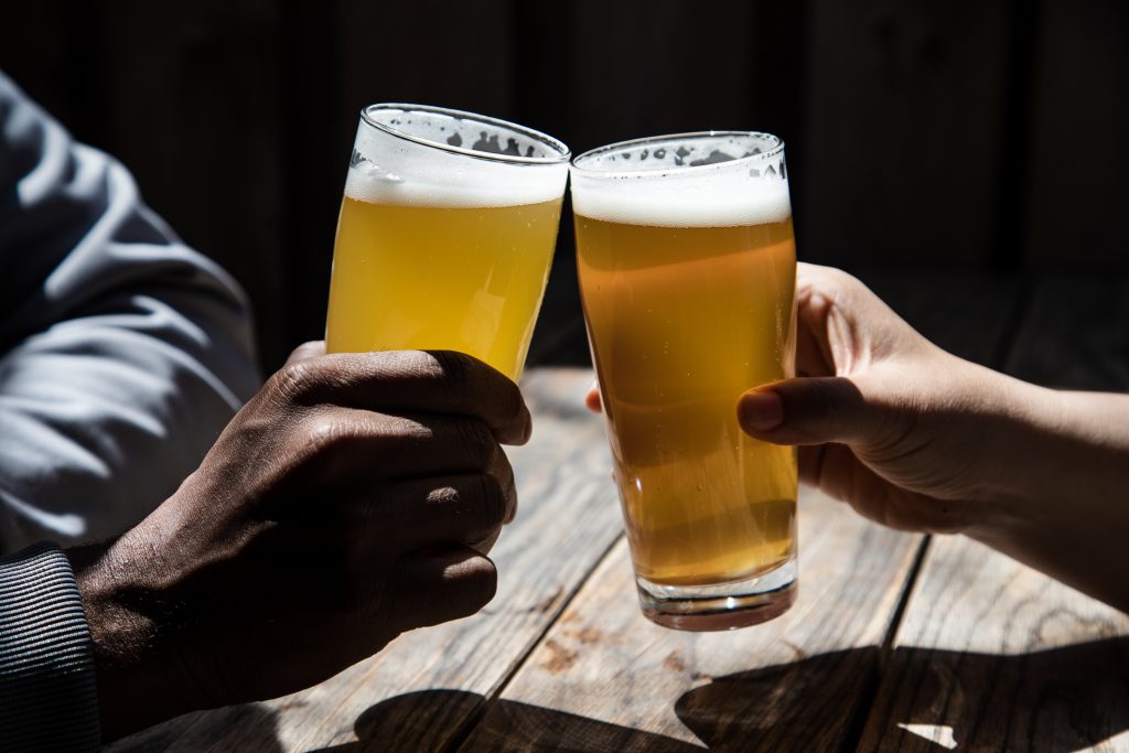 Cheers with beers on a patio. The NOW team celebrated for our list of the best brewery beers and patios in Toronto